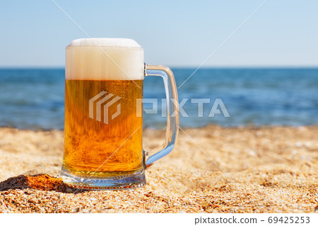 mug of beer with froth and bubbles mug of beer with froth and bubbles 69425253
