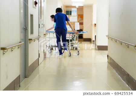 Medical worker pushing stretcher 69425534