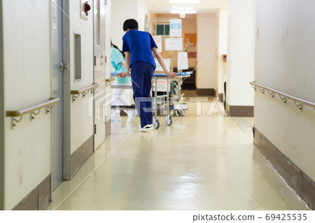 Medical worker pushing stretcher 69425535