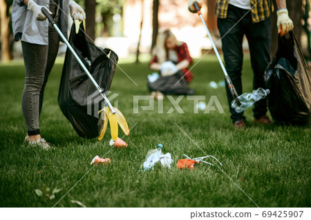Two men collects plastic garbage, volunteering Two men collects plastic garbage, volunteering 69425907