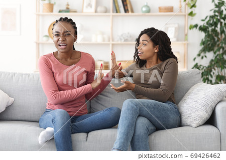 Two african american girls fighting at home Two african american girls fighting at home 69426462