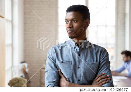 Pensive african American man look in distance thinking Pensive african American man look in distance thinking 69426677