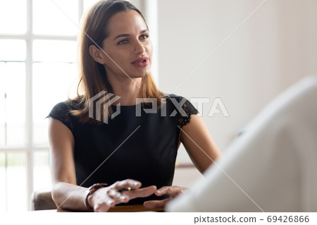 Confident Caucasian woman talk negotiating at meeting in office Confident Caucasian woman talk negotiating at meeting in office 69426866