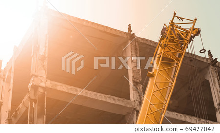 Part of a construction crane on the background of a building und 69427042