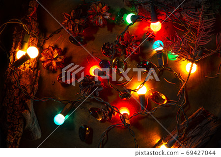 Christmas pine cones, lights and parts of tree bark. Colorful vi 69427044