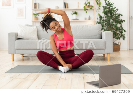 Black Girl Exercising At Laptop Having Online Training At Home 69427209