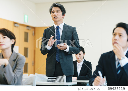 Reporter asking a question at a press conference Reporter asking a question at a press conference 69427219