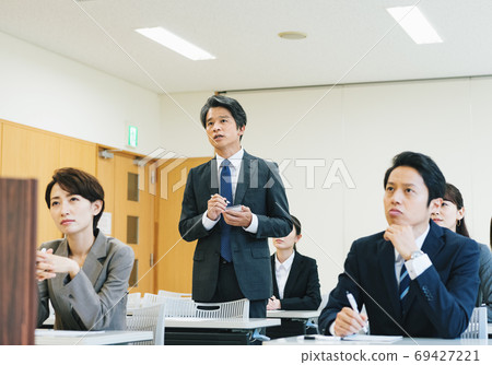Reporter asking a question at a press conference Reporter asking a question at a press conference 69427221