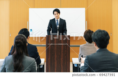 Man speaking at a lecture 69427391