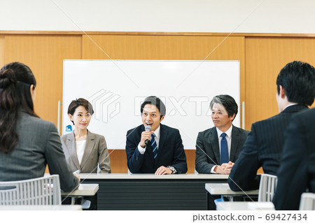 Man speaking at a press conference 69427434
