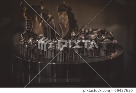 Object printed on metal 3d printer close-up. Object printed on metal 3d printer close-up. 69427650
