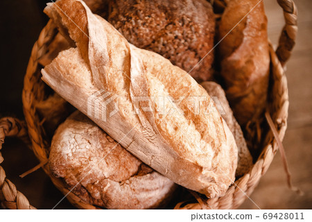 basket with several loaves of wheat and rye bread basket with several loaves of wheat and rye bread 69428011