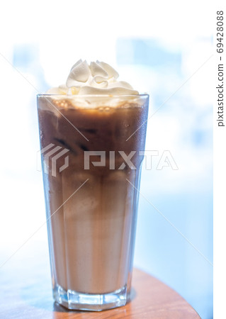 Iced coffee with whipped cream and sprinkle with almonds Iced coffee with whipped cream and sprinkle with almonds 69428088