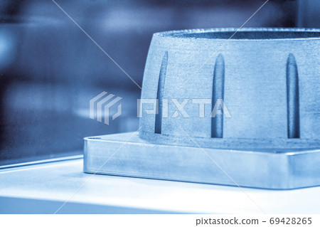 Man is holding object printed on metal 3d printer. Man is holding object printed on metal 3d printer. 69428265