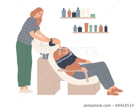 The hairdresser washes her client s hair in preparation for the haircut 69428514