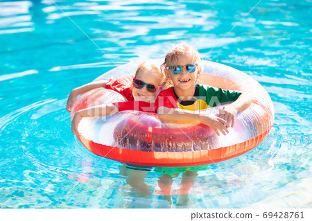 Kids in swimming pool. Life jacket for child. 69428761