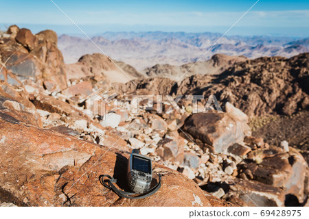 GPS navigator in desert 69428975