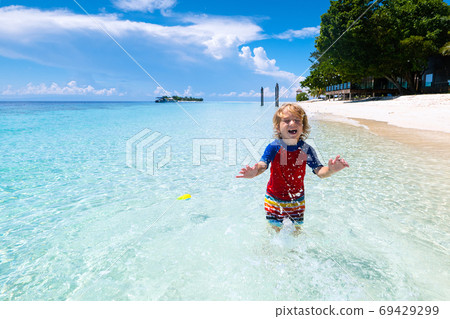 Kids playing on beach. Children play at sea. 69429299