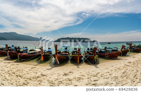 Traditional long tail tourist boats park in beautiful Sai Khao Beach, Ra Wi Island, Southern of Thailand 69429836