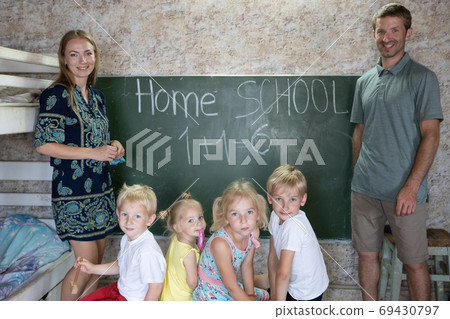 Portrait of a big family at the blackboard at home school. 69430797