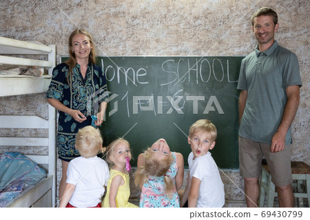 Portrait of a big family at the blackboard at home school. 69430799