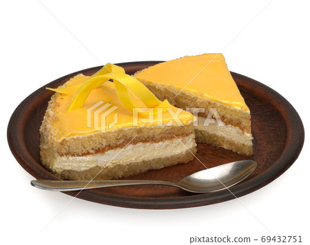 Two pieces of biscuit cake with cream and lemon cream on a plate. Two pieces of biscuit cake with cream and lemon cream on a plate. 69432751