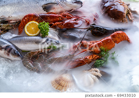 Fresh seafood on ice background. Fresh seafood on ice background. 69433010