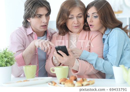 Happy family of three spending time together at dinner Happy family of three spending time together at dinner 69433791