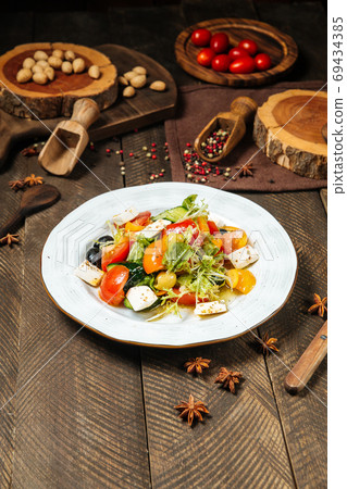 Greek vegetable salad with feta cheese and olives 69434385