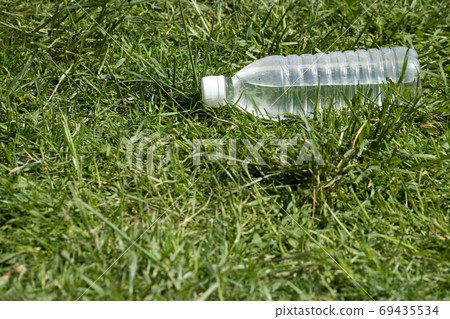 Bottle water and grass 69435534