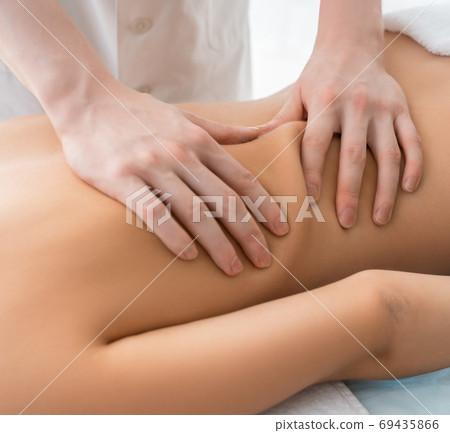Nude woman being massaged cropped view 69435866