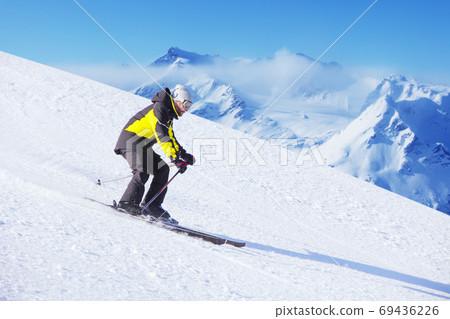 Alpine skier on piste ride downhill Alpine skier on piste ride downhill 69436226