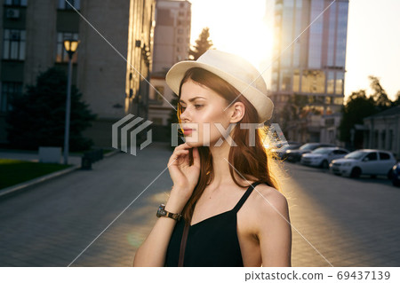 fashionable woman on city street in black dress and hat glasses makeup model watch on hand fresh air fashionable woman on city street in black dress and hat glasses makeup model watch on hand fresh air 69437139