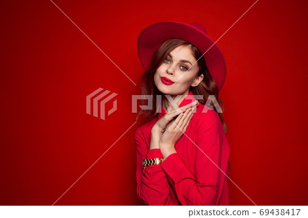 woman in red shirt with bright makeup and hat on her head emotions fashion style woman in red shirt with bright makeup and hat on her head emotions fashion style 69438417