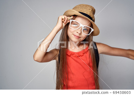 little girl wearing hat schoolgirl learning education red t shirt little girl wearing hat schoolgirl learning education red t shirt 69438603