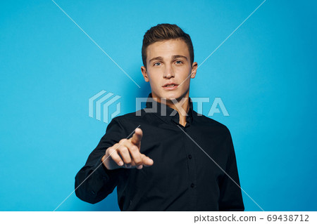 emotional man in black shirt studio lifestyle blue isolated background emotional man in black shirt studio lifestyle blue isolated background 69438712
