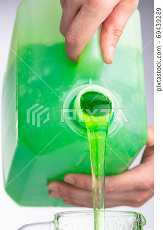 liquid soap in plastic bottle, pouring by hands liquid soap in plastic bottle, pouring by hands 69439289