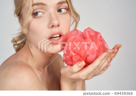 pretty blonde pink washcloth in hand bare shoulders clear skin showering 69439368