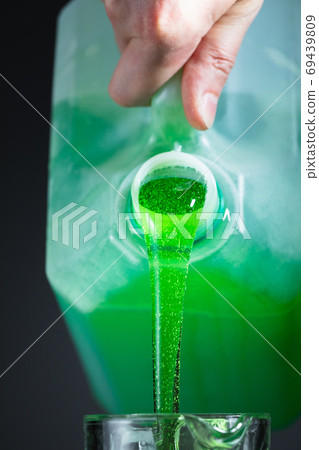 liquid soap in plastic bottle, pouring by hand 69439809
