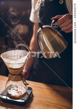 man is making fresh-ground coffee man is making fresh-ground coffee 69440079