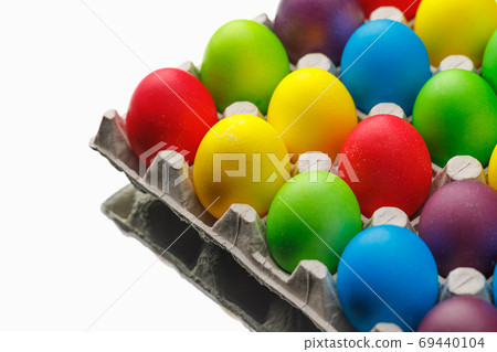 Easter festive multicolor eggs carton, white background Easter festive multicolor eggs carton, white background 69440104