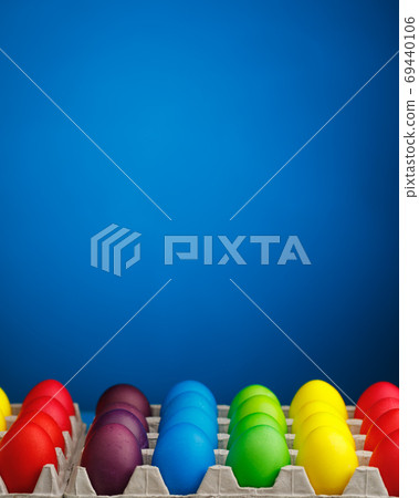 Easter festive multicolor eggs carton, blue background Easter festive multicolor eggs carton, blue background 69440106