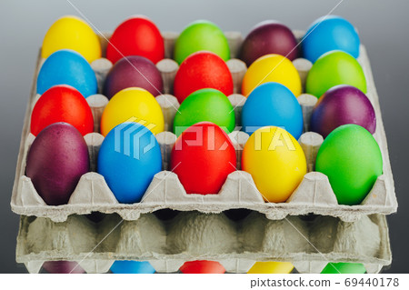 Easter festive multicolor eggs carton, gray background Easter festive multicolor eggs carton, gray background 69440178