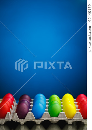 Easter festive multicolor eggs carton, blue background Easter festive multicolor eggs carton, blue background 69440179