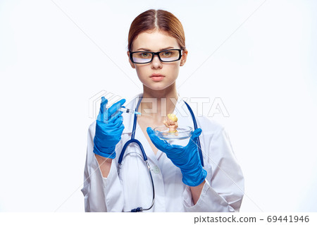 doctor woman in blue gloves with stethoscope nurse with glasses injection syringe laboratory light background doctor woman in blue gloves with stethoscope nurse with glasses injection syringe laboratory light background 69441946