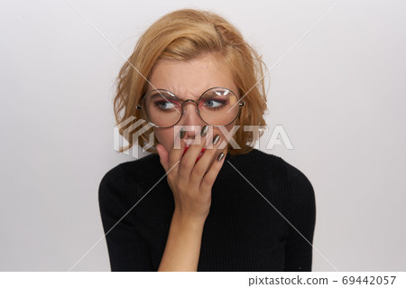 Cute blonde in glasses bright makeup black jacket cropped view light background emotions Cute blonde in glasses bright makeup black jacket cropped view light background emotions 69442057