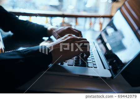 Business man freelancer working in a cafe laptops communication phone room manager model 69442079