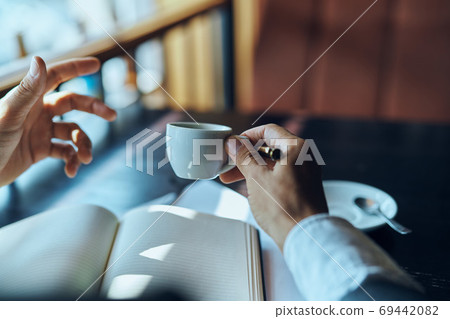 businesswoman in a cafe with a book on the table documents a cup of coffee work lifestyle 69442082