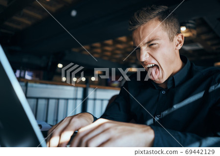 Business man freelancer working in a cafe laptops communication phone room manager model 69442129