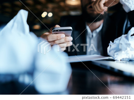 business man sitting at table in front of laptop crumpled paper lifestyle executive job technology business man sitting at table in front of laptop crumpled paper lifestyle executive job technology 69442151